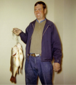 Dad was an ace fisherman. Here he shows off a good day's catch of bass.