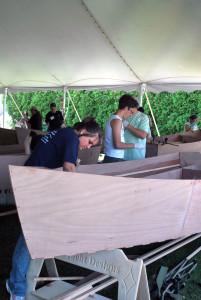 Girl building wooden boat at the wooden boat show